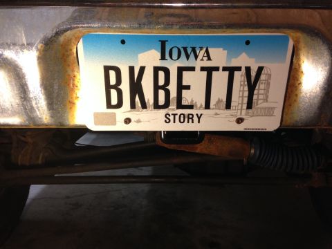 1979 Ford Bronco - The license plate is attached to the rear of a vehicle, showing some rust on the bumper.