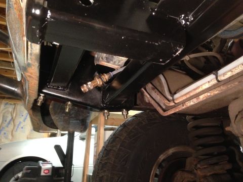 1979 Ford Bronco - Winch mount hardware attached to vehicle frame, with suspension and tire visible.
