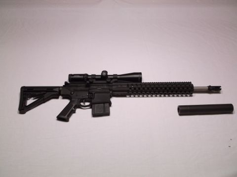 1995 Mercury Grand Marquis - A rifle with a scope and a separate suppressor is displayed against a white background.