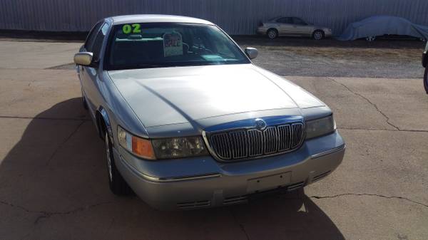 Silver Mercury Grand Marquis front view with 02 sign in windshield