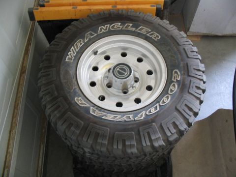 1996 Ford Bronco - A spare tire with a Goodyear Wrangler tread pattern is shown mounted on a silver rim.