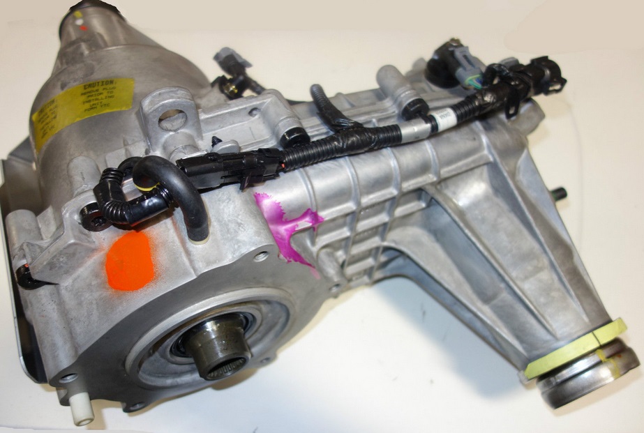 Silver automatic transmission assembly with electrical connectors and wiring.