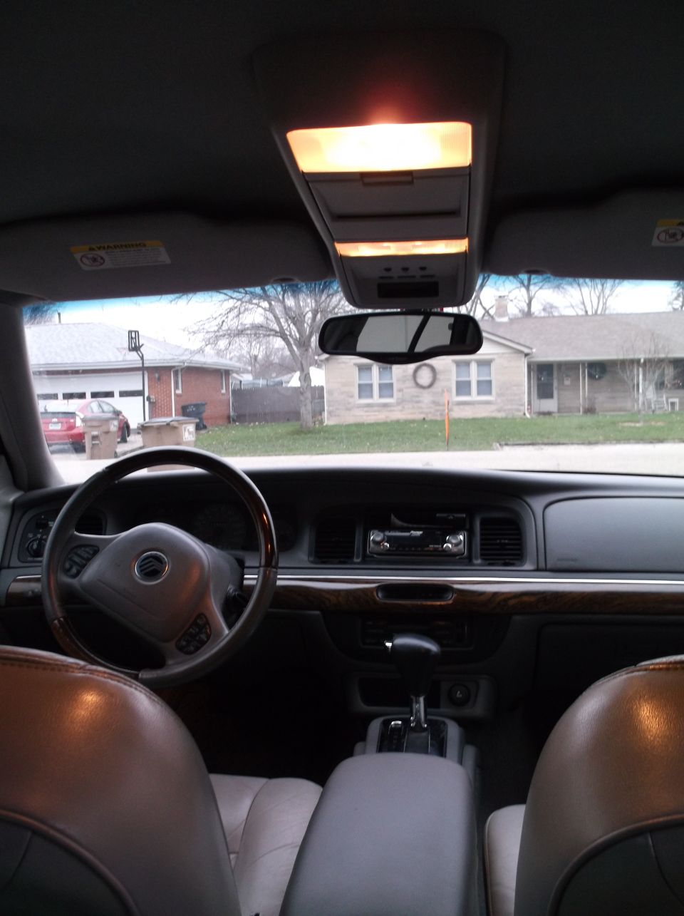 Interior view of a 1999 Mercury Grand Marquis, showing dashboard, steering wheel, and seats.