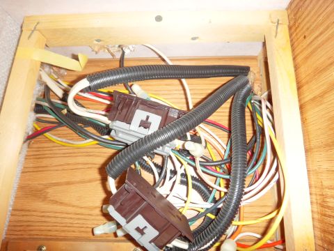 1995 Chevrolet P30 1 Ton - Step Van - A close-up view of a complex wiring harness with multiple connectors and corrugated tubing, likely part of a vehicle's electrical system. T…