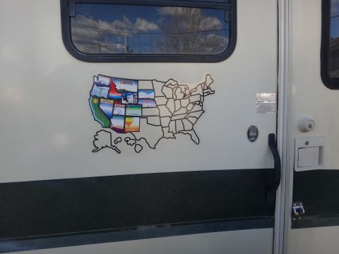 1995 Chevrolet P30 1 Ton - Step Van - A sticker depicting the continental United States with individual states marked with small images is affixed to the side of a white RV. The…