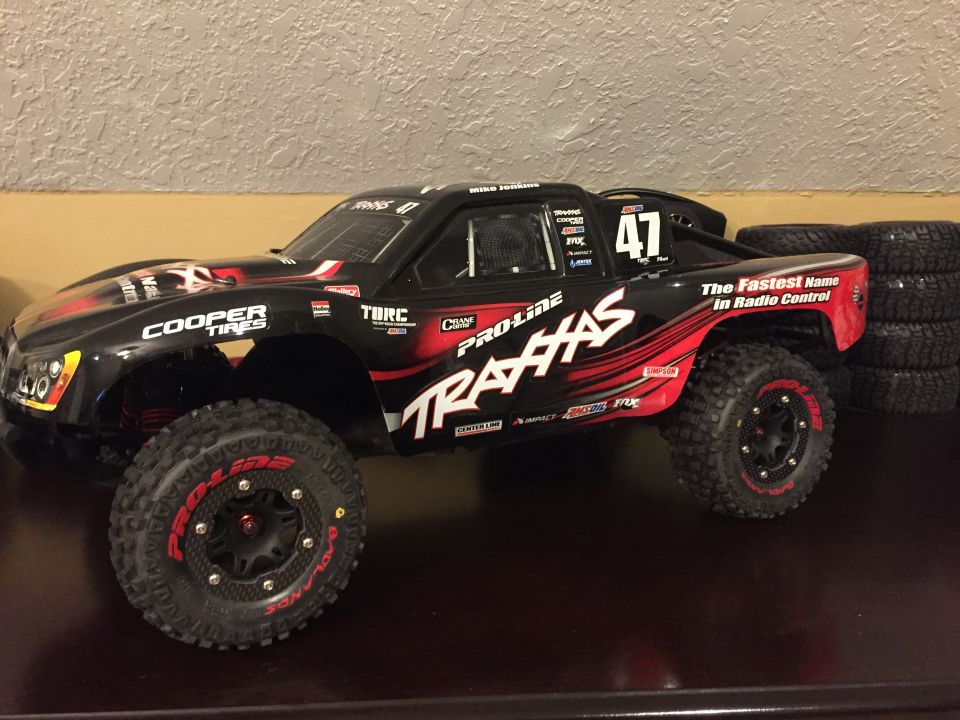 Black and red Pro-Line Traxxas remote-controlled short-course truck with sponsor decals.