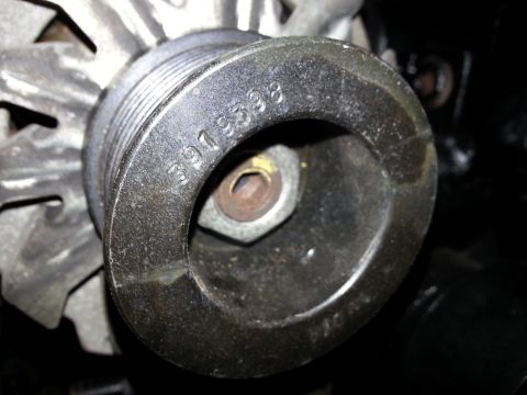 1994 Ford Bronco - A close-up view of a pulley with the part number "3979398" stamped on it. The pulley appears to be part of an engine component, possibly an…