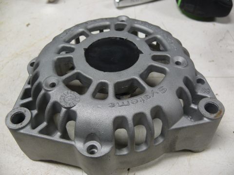 Gray alternator housing with black center insert and embossed text.