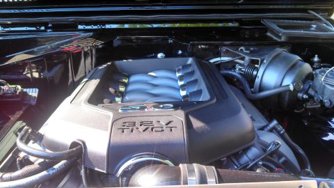 1979 Ford Bronco - Close-up view of a black Ford Bronco engine bay, featuring a 32V Ti-VCT engine with a polished intake manifold. The engine is clean and app…