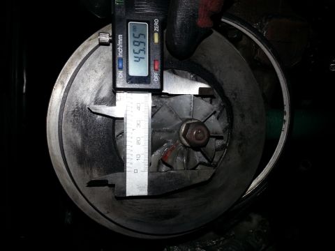 1994 Ford Bronco - A digital caliper measures the diameter of a turbocharger's impeller, showing a reading of 45.95 mm. The impeller is mounted within a housi…