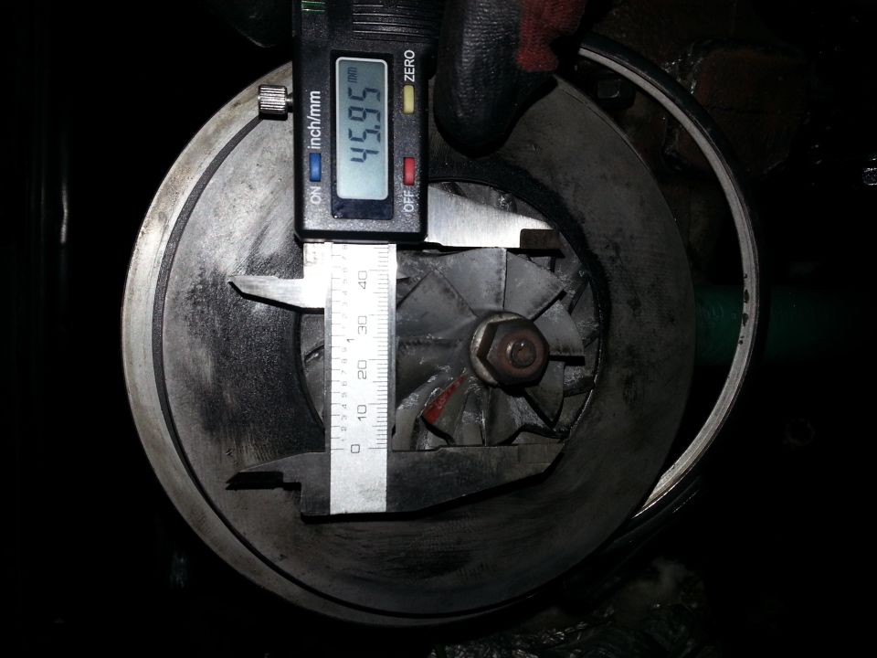 Digital caliper measuring turbocharger impeller diameter at 45.95 mm.