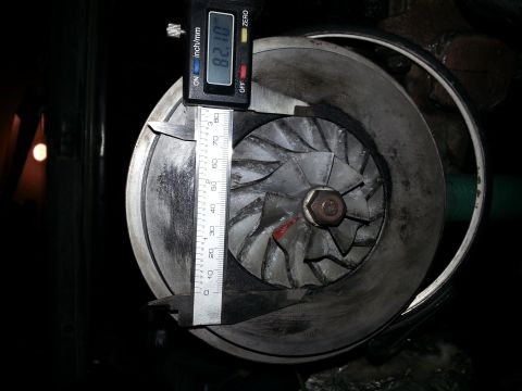 1994 Ford Bronco - A digital caliper is used to measure the diameter of a turbocharger's impeller blades.
