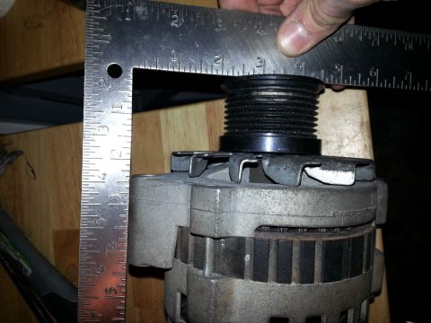 1994 Ford Bronco - Measuring the pulley diameter of an alternator with a metal ruler.