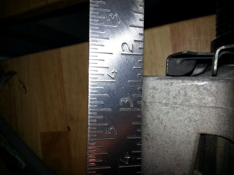 1994 Ford Bronco - A ruler is used to measure a metal part, with markings visible up to 4 inches.