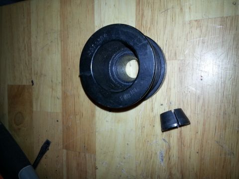 1994 Ford Bronco - A pulley and a split wedge are shown on a wooden surface. Part number 3612266 is visible on the pulley.