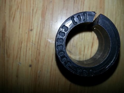 1994 Ford Bronco - A close-up view of a black, split circular part with stamped numbers and markings.