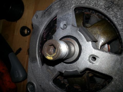 1994 Ford Bronco - A disassembled alternator part is shown with its internal components visible.