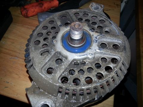 1994 Ford Bronco - This is a close-up view of a vehicle alternator, showing wear and tear on the component.