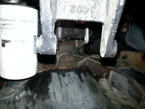 1994 Ford Bronco - Close-up of a Cummins lube filter and a cast metal bracket with visible part number.