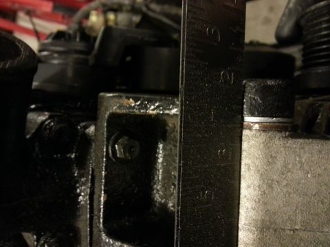 1994 Ford Bronco - A ruler is used to measure an engine part, likely for an installation or repair.