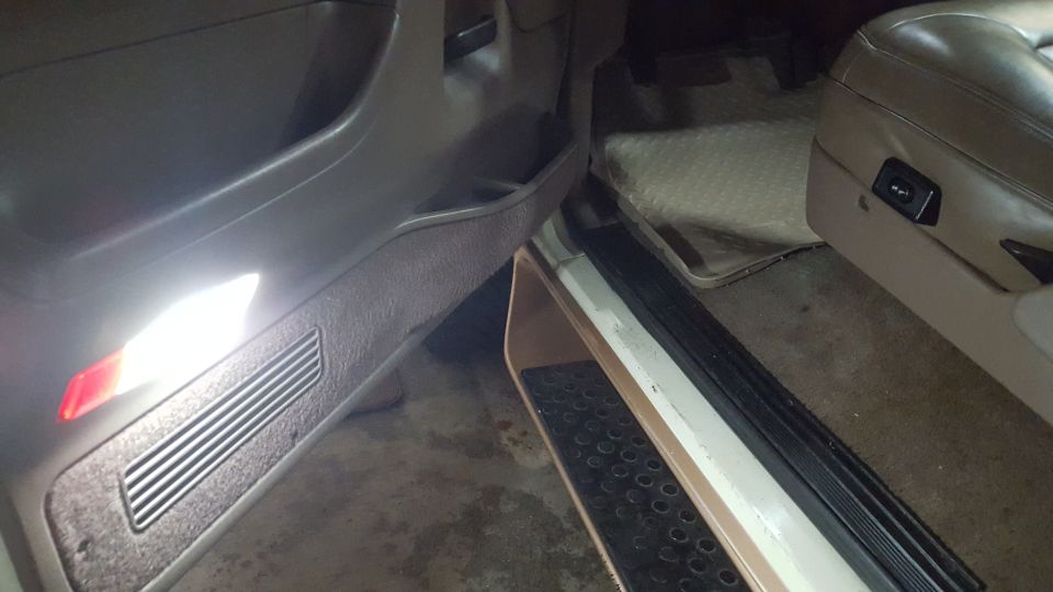 Interior of a vehicle showing the driver's side door panel and seat.