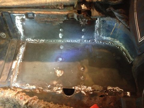 1979 Ford Bronco - The image shows the interior floor of a vehicle that has undergone repair, likely for rust. Welds and new metal patches are visible on the…