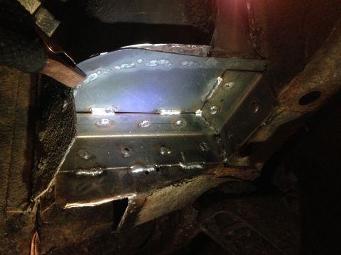1979 Ford Bronco - A close-up view shows freshly welded metal plates reinforcing the frame of a vehicle, likely during a restoration or repair process. The su…
