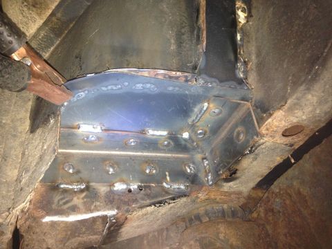 1979 Ford Bronco - This image shows a close-up view of metal fabrication work being done on the undercarriage of a vehicle, likely a repair or reinforcement o…
