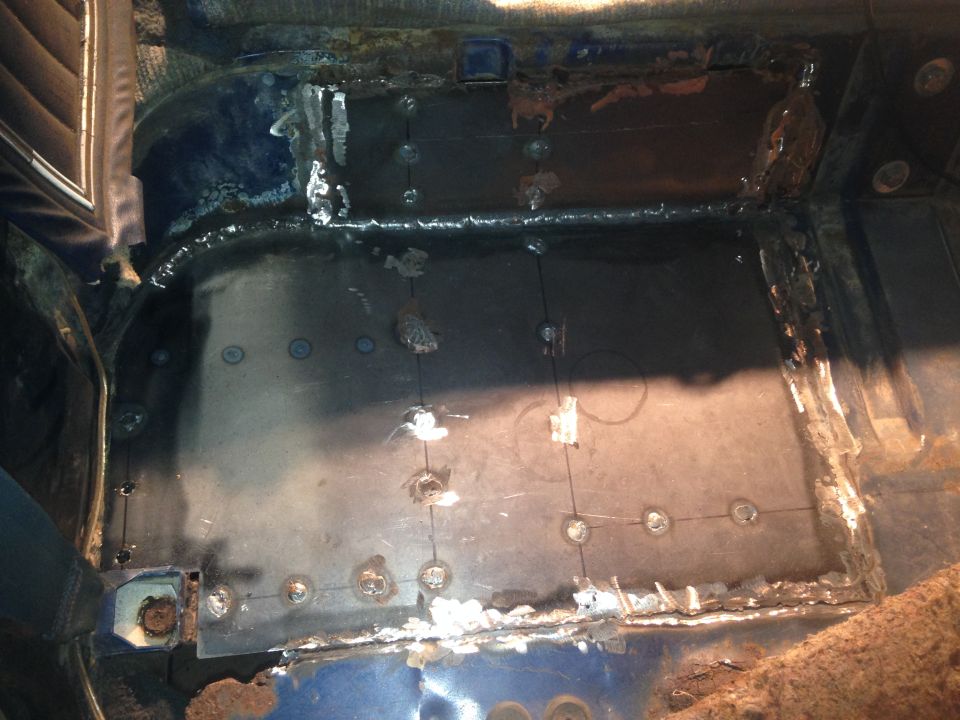 Welding and rust repair on the interior floor of a vehicle.