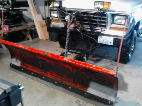 1973 Ford F-250 - A snow plow is attached to the front of a pickup truck. The truck has a license plate that reads "B58945W" and appears to be silver or whit…