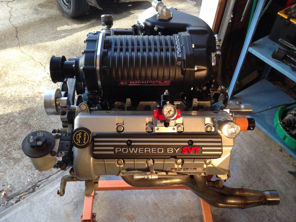 Supercharged V8 engine with Whipple supercharger, on an engine stand.