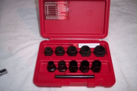 1973 Ford F-250 - A red plastic case containing a set of black bolt extractors. The lid of the case is open and displays a chart with bolt sizes.