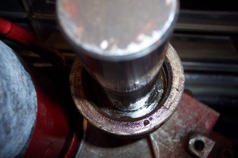 1973 Ford F-250 - A close-up view shows a metal shaft inserted into a greased housing, likely part of a vehicle's mechanical system. The surrounding componen…