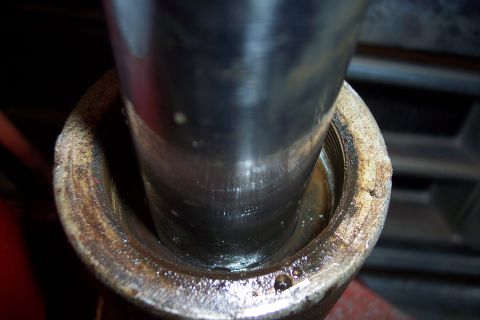 1973 Ford F-250 - A close-up view shows the inside of a metal pipe with visible threads and some oil or fluid. A larger, smooth metal cylinder is inserted in…