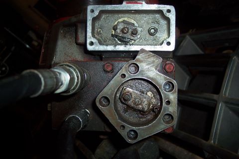 1973 Ford F-250 - A close-up view of two hydraulic pump components, likely from a vehicle's power steering or plow system, showing metal housings, fittings,…