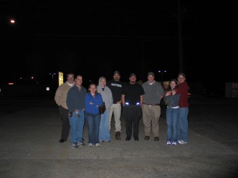 1995 Ford Bronco - A group of people gathered outdoors at night.