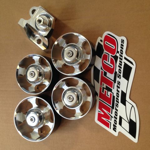 2004 Ford Crown Victoria - A collection of polished metal pulleys and a bracket are laid out on a brown cardboard surface next to a "METCO Motorsports Solutions" stic…