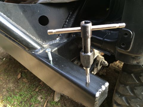 1987 Suzuki Samurai - Photograph of a tap tool being used on a fabricated bumper, not a technical document.