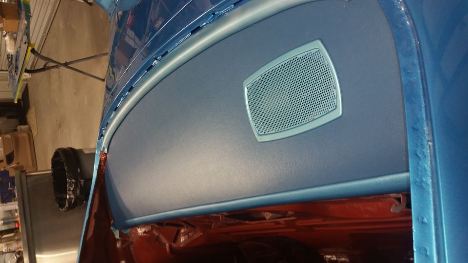 Interior dashboard of a blue 1970 Pontiac Trans Am with a speaker grille.
