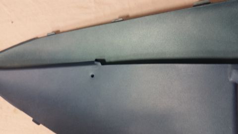 2015 Chevrolet new - Two dark gray plastic automotive trim pieces are shown, one above the other, with a small hole visible on the lower piece.