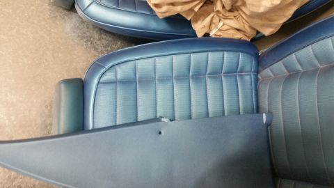 2015 Chevrolet new - A close-up view shows the blue upholstered interior of a vehicle, likely seats and a door panel. The upholstery features a quilted pattern…