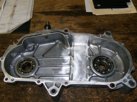 2000 Ford E350 - A close-up view of the inside of an aluminum engine or transmission casing, showing two ball bearings and visible weld repairs along the se…