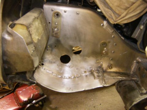 2000 Ford E350 - This image shows a close-up view of the undercarriage of a vehicle, focusing on metal fabrication work. Visible are newly welded seams, dri…