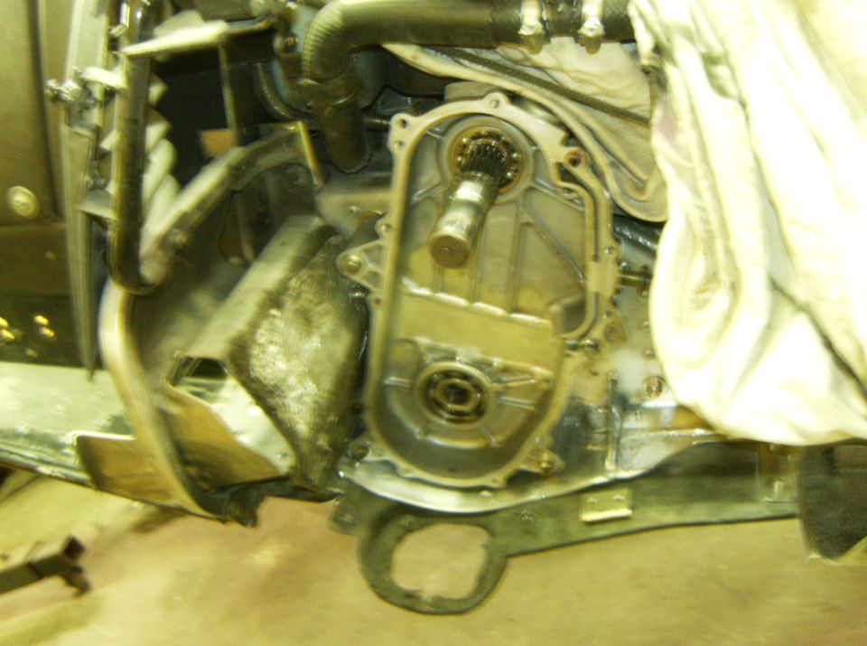 Ford E350 engine compartment with transmission housing removed, showing gears and bearings.