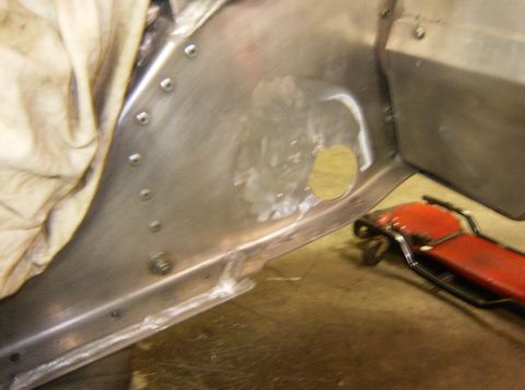 2000 Ford E350 - The image shows a close-up view of the interior of a vehicle's metal bodywork, likely a van or truck, with visible rivets and some repair w…