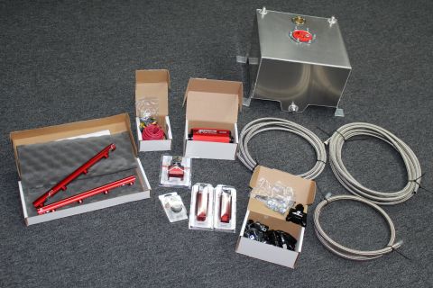 2003 Ford Crown Victoria - Collection of automotive fuel system components including fuel rails, a fuel tank, and braided lines.
