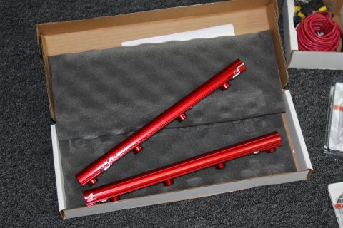 2003 Ford Crown Victoria - Red aluminum fuel rails are packaged in a box with foam, ready for installation.