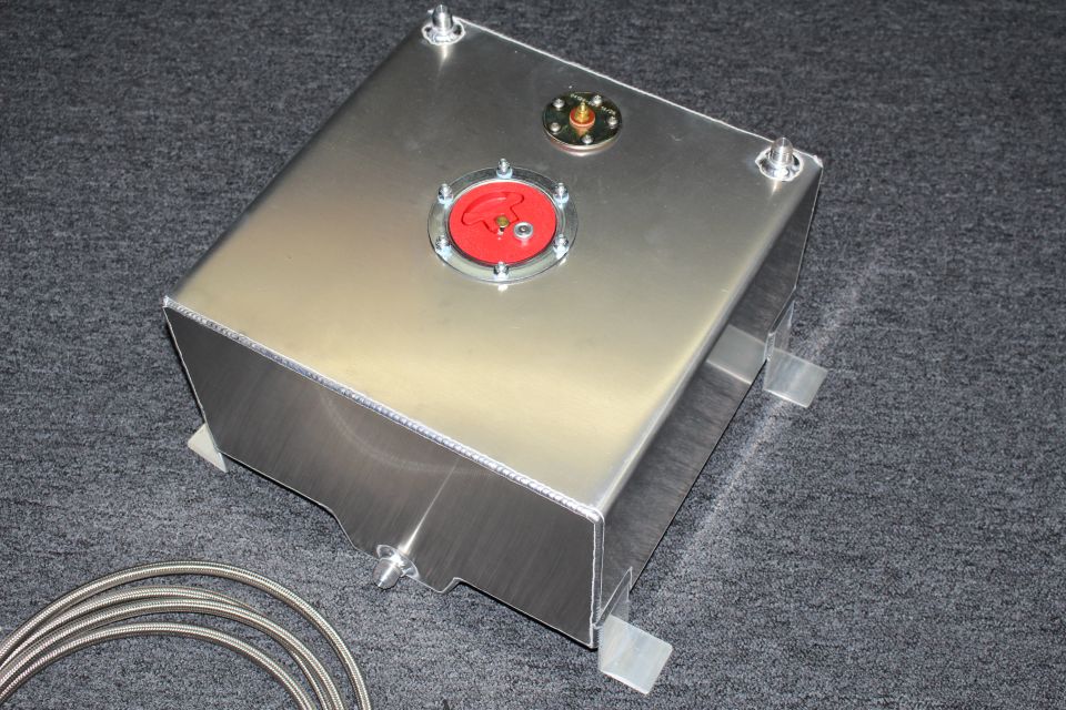 Brushed aluminum fuel cell tank with red cap fitting and mounting feet, with braided line on gray carpet