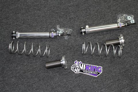 2003 Ford Crown Victoria - Two Viking shock absorbers laid out with two coil springs and a threaded billet sleeve beside a Viking Performance decal on gray carpet.