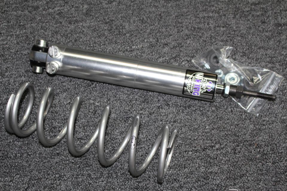 Polished Viking shock absorber with bagged hardware and a coil spring on dark gray carpet